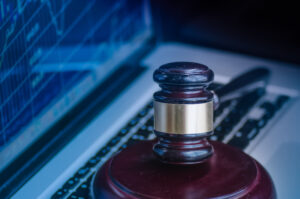 Judges' gavel on the keyboard with a computer screen displaying stock reports in the background illustrates Trafigura's lawsuit.