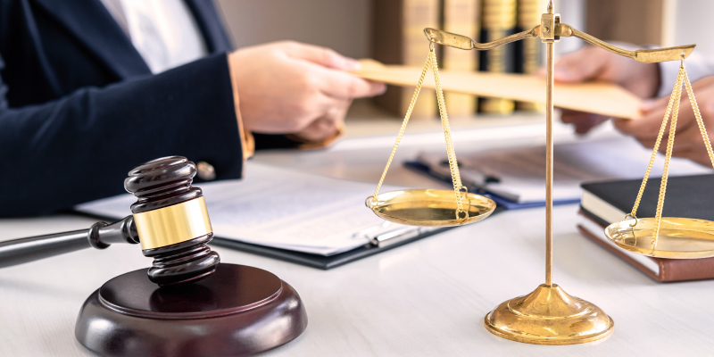 Closeup shot of a lawyer working in courtroom have meeting with client illustrate the Agritrade allegation where the Ex-CFO was jailed 20 years after duping financial institutions.